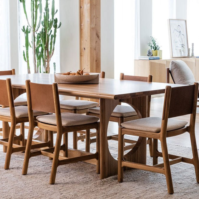 Avon Dining Chairs around a rectangular wood dining table in a bright, modern living space with natural light and minimalist style.
