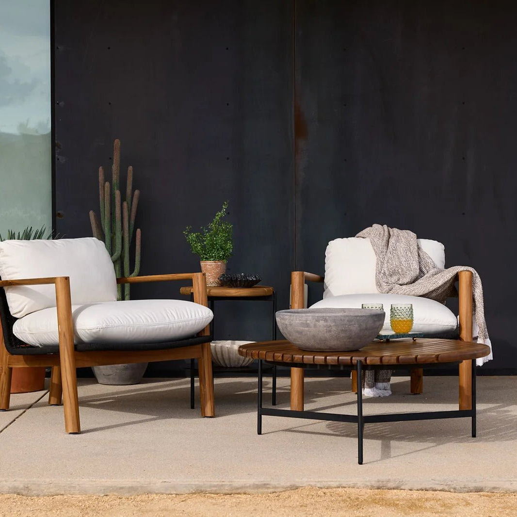Modern outdoor lounge chairs with white cushions and table, styled for Denver Modern’s Closeouts & Clearance collection.