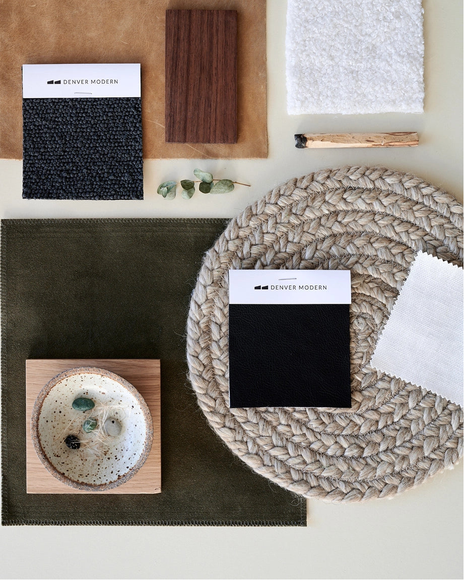 Flat lay of Denver Modern design materials including fabric swatches, leather, wood, and finishes