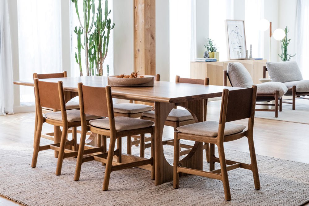 Avon Dining Chairs around a rectangular wood dining table in a bright, modern living space with natural light and minimalist style.