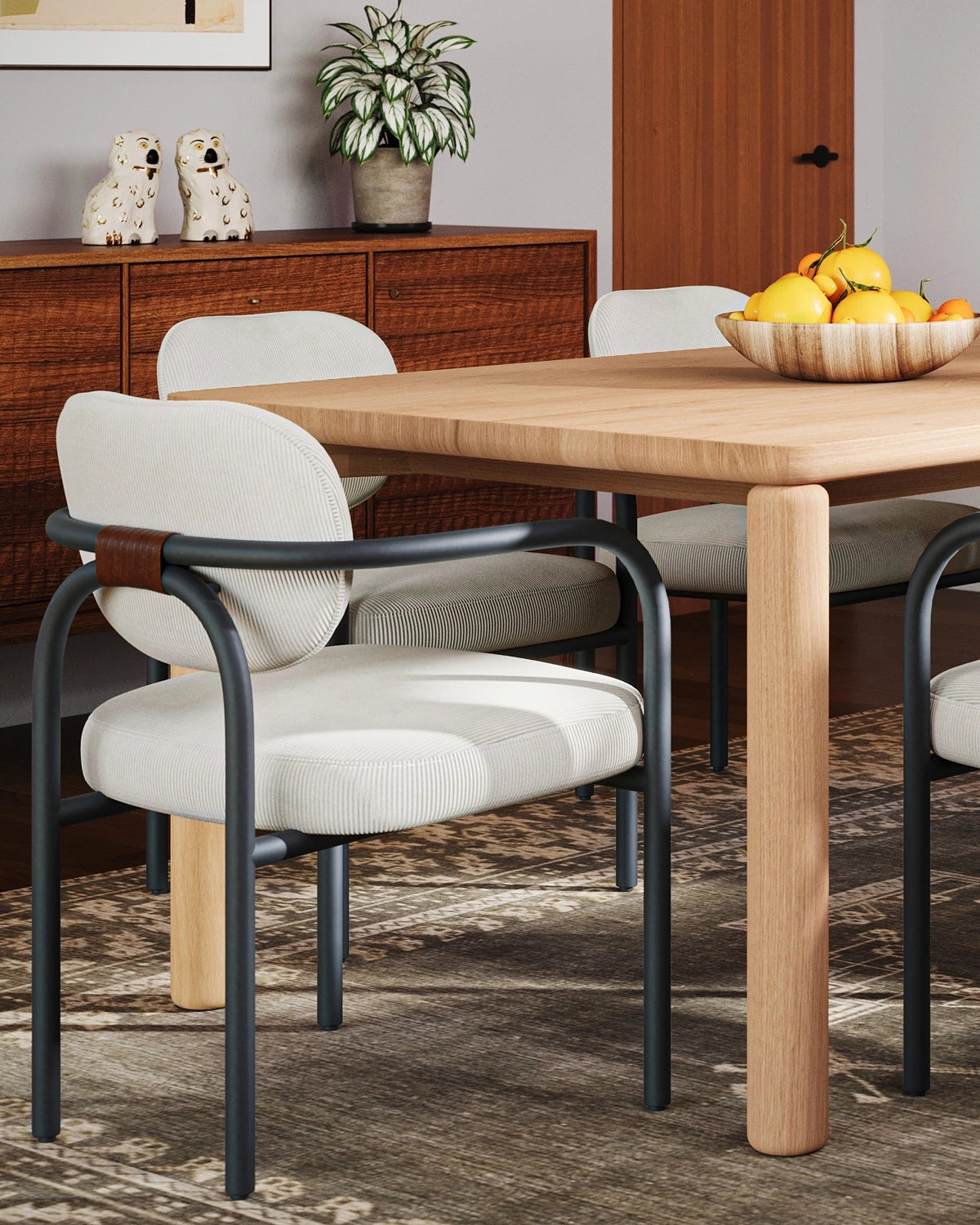 Arches Dining Chair with upholstered seat and curved metal frame styled at a modern dining table