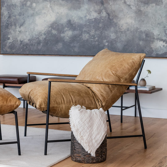 a chair and stool in a room