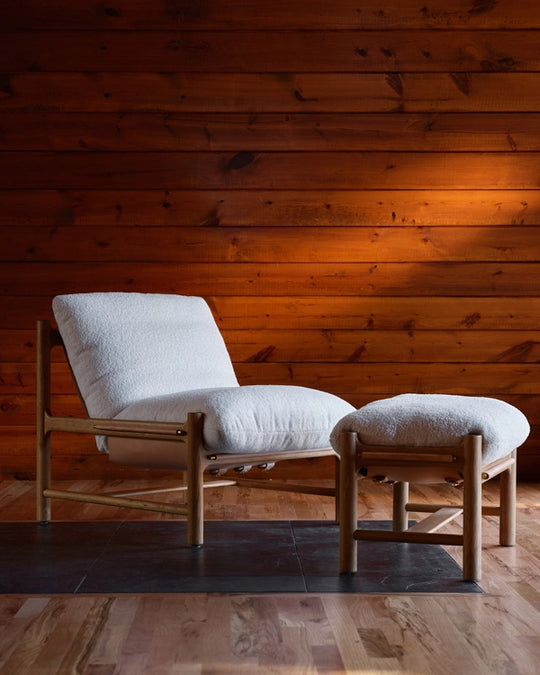 a chair and ottoman in a room