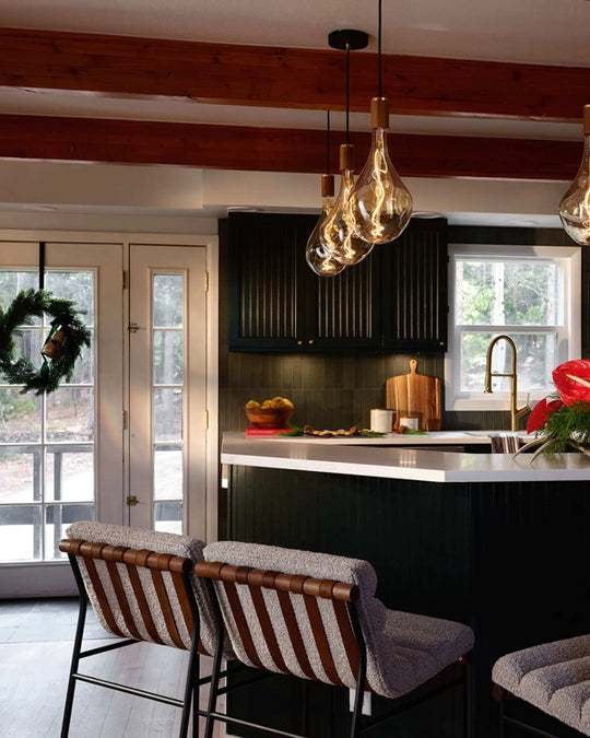 a kitchen with a bar and chairs