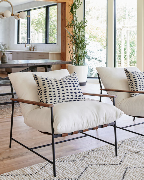 a room with white chairs and a table