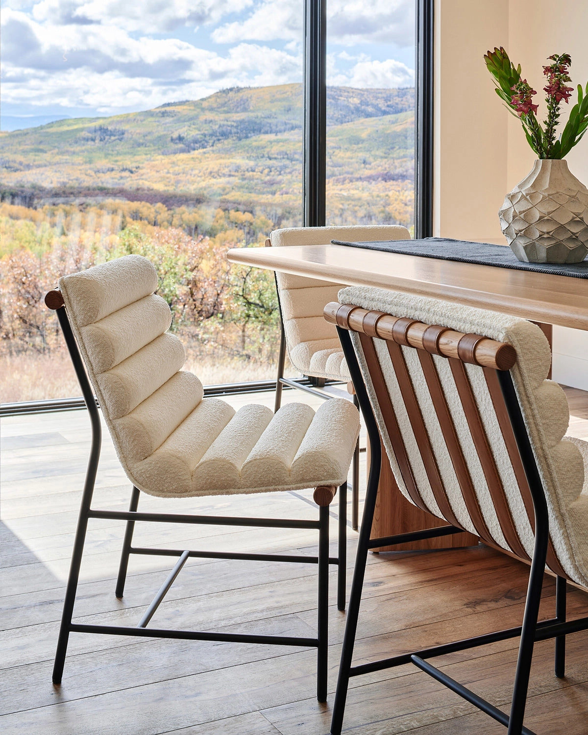 Vail Dining Chairs in white oak with boucle upholstery styled at a modern dining table