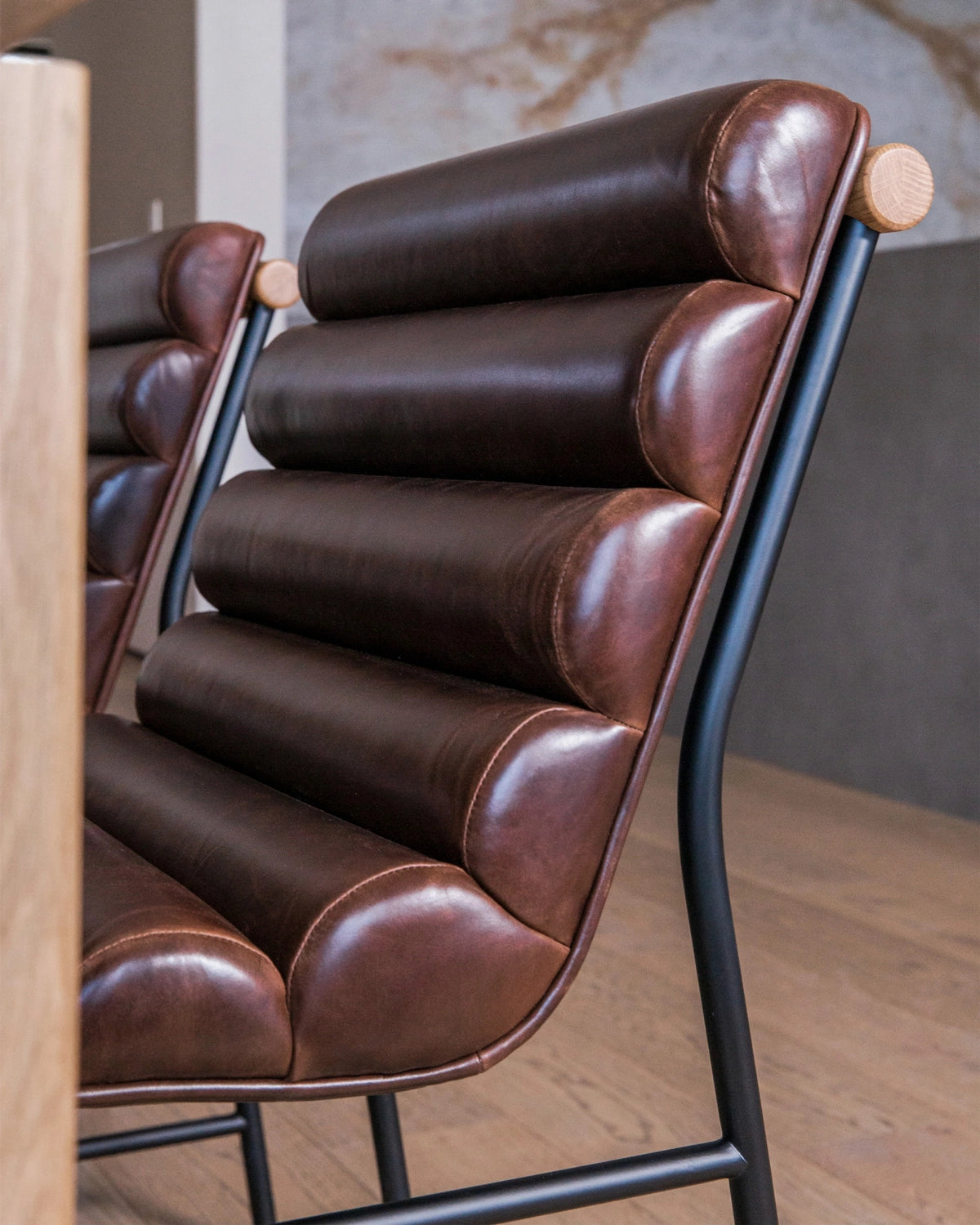 Vail Dining Chair with maple frame and brown leather seat featuring cushioned horizontal channels