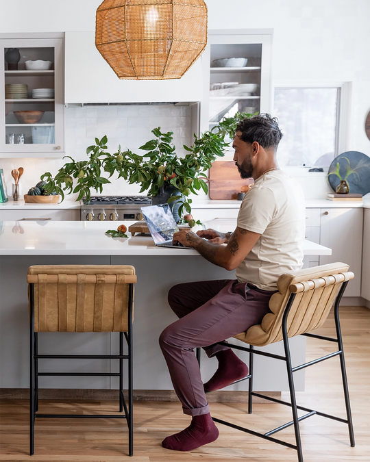 a man sitting at a table in a kitchen