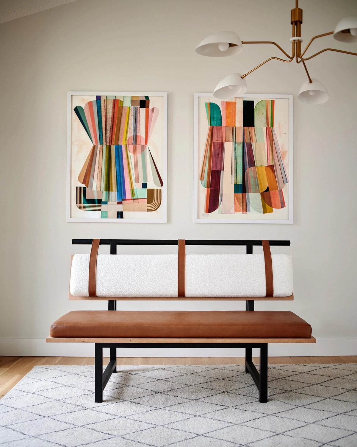 Banquette bench styled in a modern dining space with leather seat cushion, upholstered backrest, and black metal legs