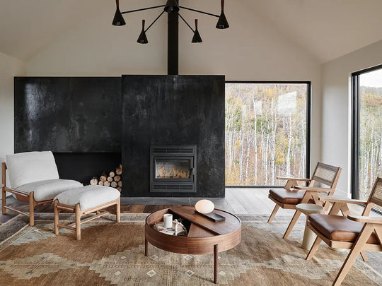 a room with a fireplace and chairs