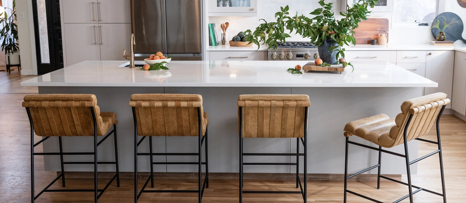 a kitchen with a white island and a white countertop