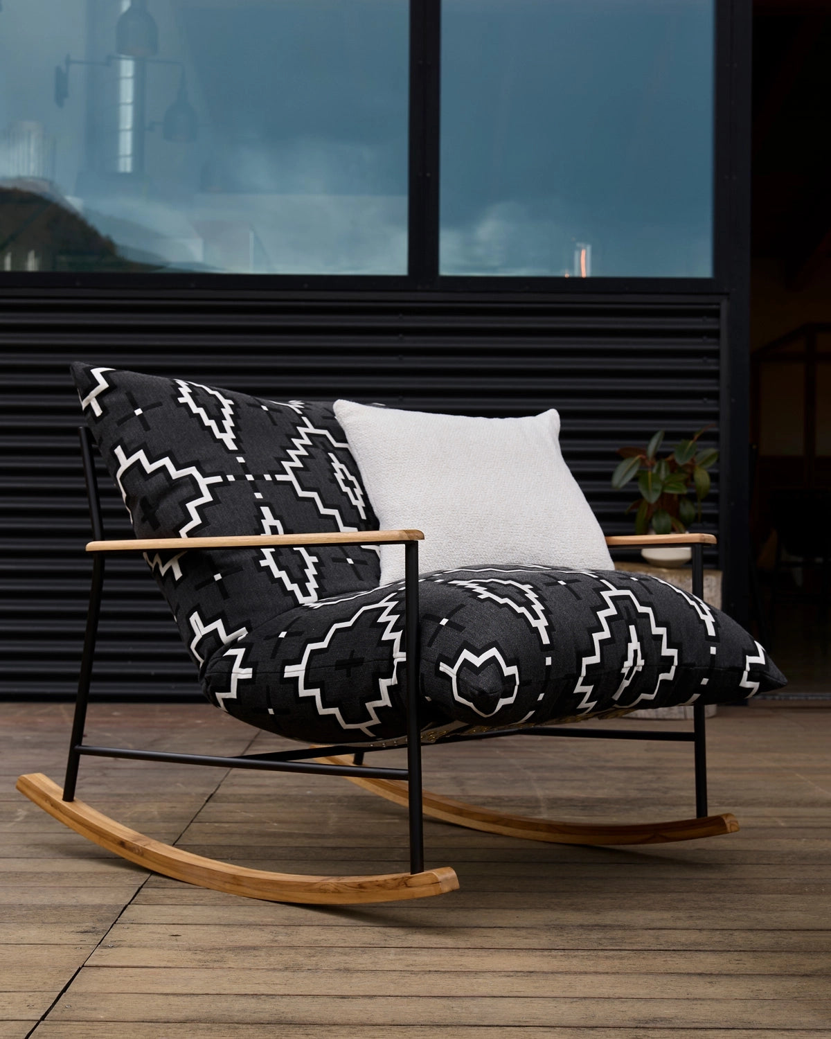 Outdoor Vail Rocking chair with black and white Pendleton® patterned cushions on a wooden deck.