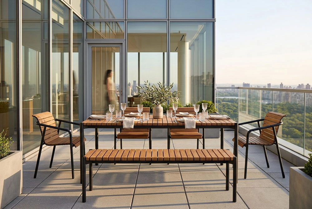 Outdoor dining set featuring the Outdoor Strata Dining Bench on a balcony with cityscape view
