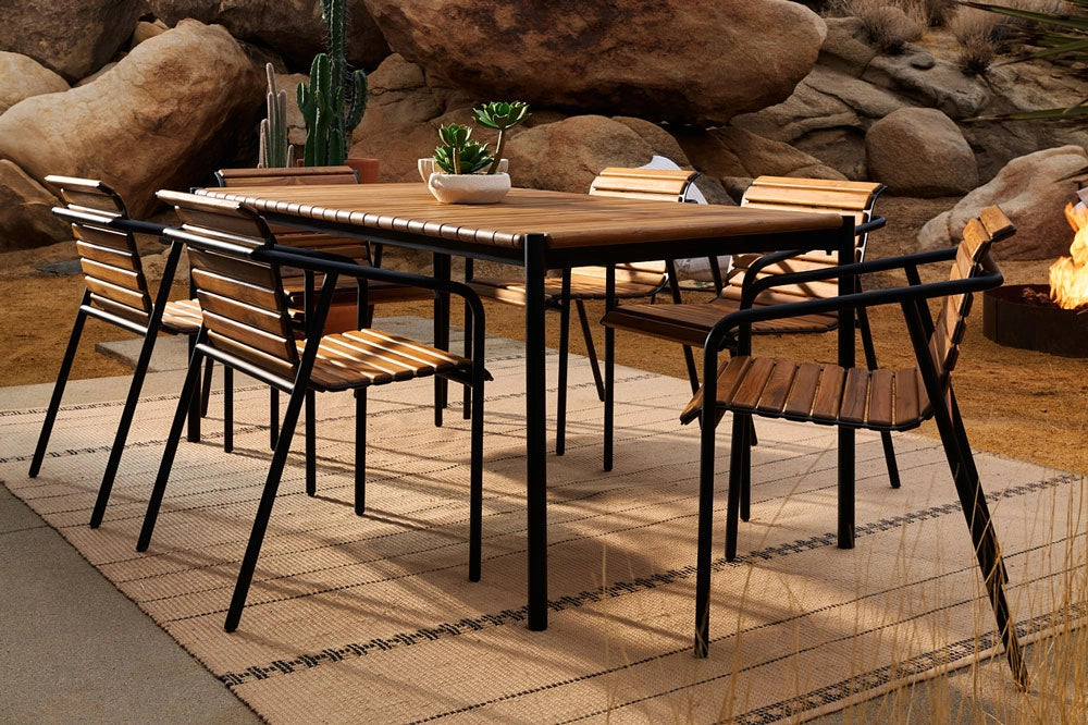 Outdoor dining set with Strata Dining Table and Strata Dining Chairs in a natural setting