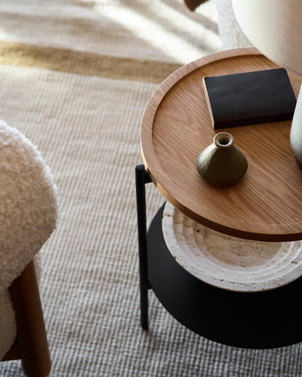 a table with a vase and a book on it