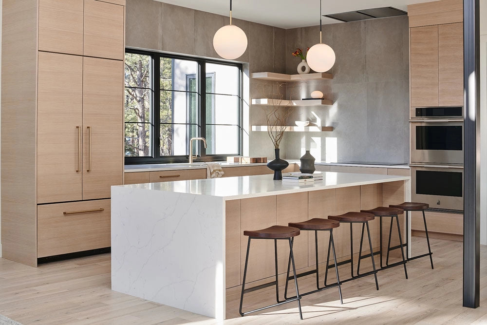 Modern kitchen with wooden cabinets, island, and Yuma Counter Stools.